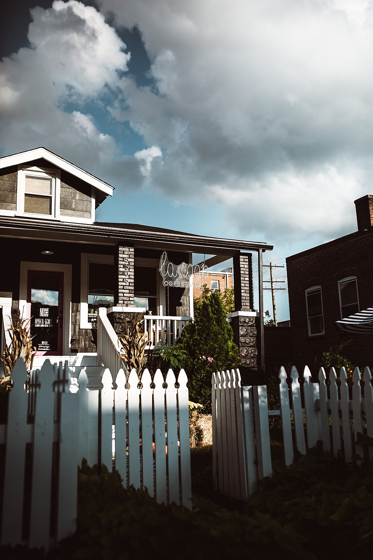exterior of la coop coffee with dramatic sky behind