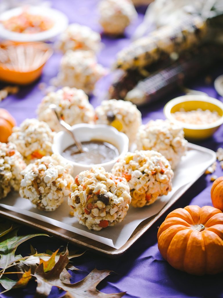 backlit scene of caramel popcorn balls and fall decor