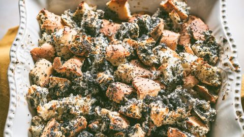 Hungarian poppy seed bread pudding in a white dish on wooden board