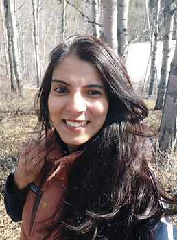 headshot of Lopa looking at camera in winter coat in Whitehorse Canada