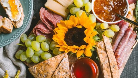 thumbnail image of autumnal charcuterie and cheese board with sunflowers, goldenrod, and harvest-themed colors